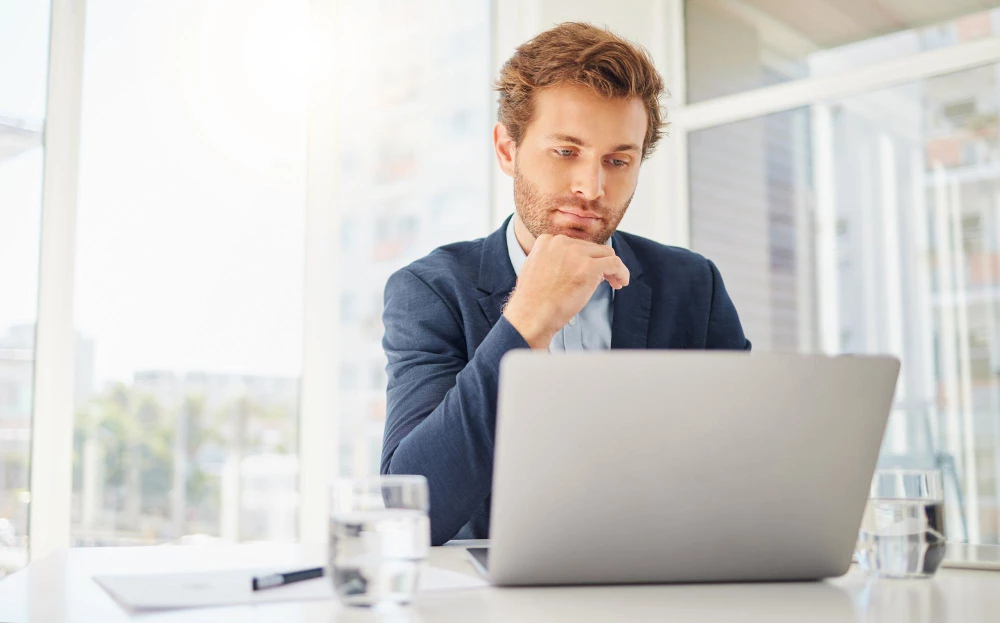 man on computer looking at various google apps
