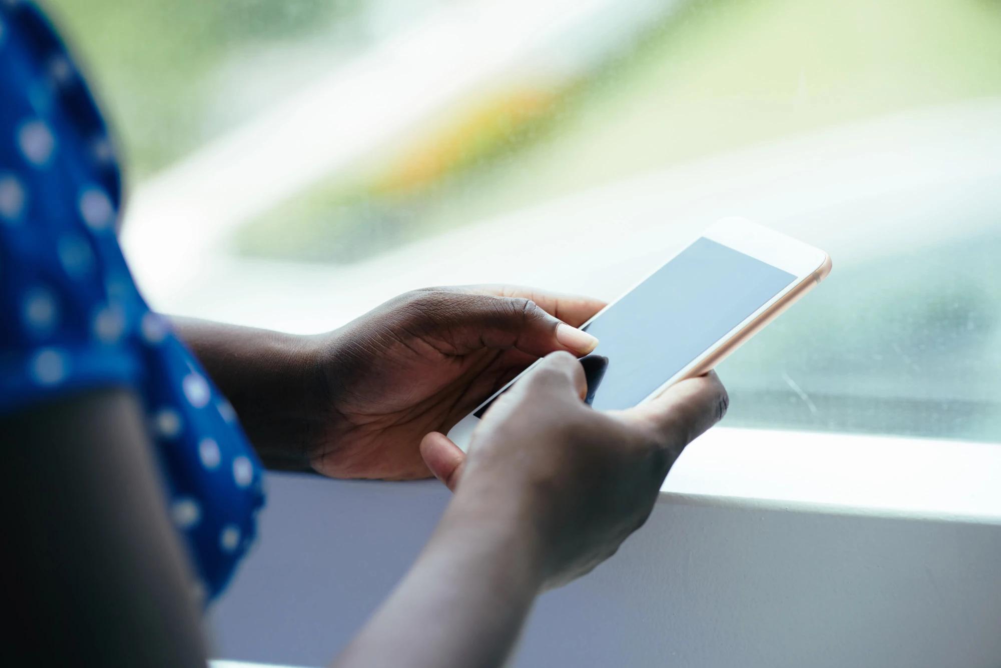 lady holding phone viewing a landing page example