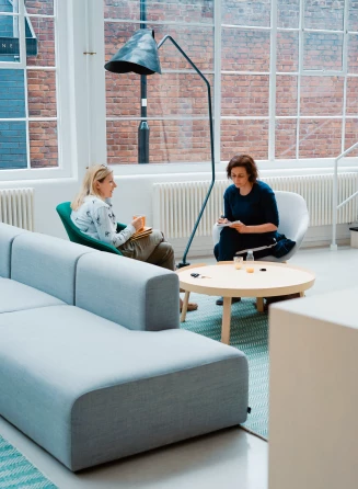 Two women having a meeting in a spacious meeting environment
